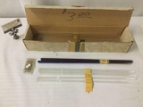 Box full of glass artists tubes, approx. 19x4x4 inches.