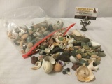 Bag full of seashells, shark teeth, and rocks, approx. 10x8x3 inches.