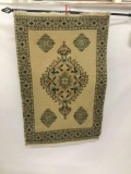 Hanging Eastern rug with geometric and floral pattern