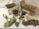 Two boxes full of decorative tassels and towel rings, approx. 21x13x18 inches.