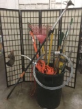 Trash can filled with 15 shovels, axes, a weed whacker (tested&working), & more, approx. 86x50x33