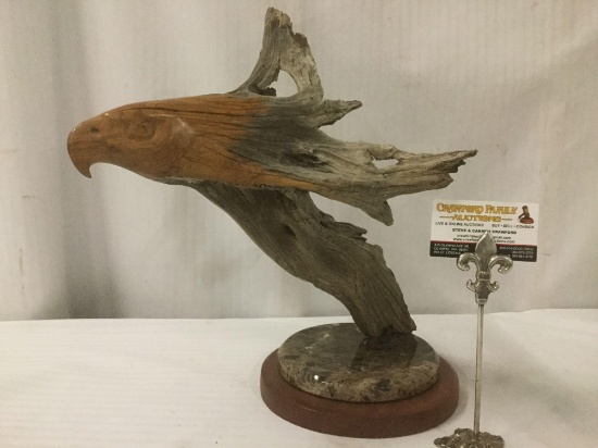 Carved driftwood eagle sculpture atop a marble and wood base - native Hawaiian wood sculpture