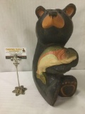 Carved and painted wooden sculpture of a bear with a salmon signed BSC by Big Sky Carvers