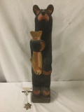 Large carved & painted wooden sculpture of a bear with a salmon signed BSC by Big Sky Carvers