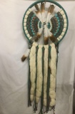 Large blue woven Native American dream catcher with feathers, woven thread, beads and furs