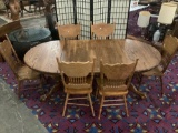 Antique style oak pedestal base claw foot dining table with 2 cleaves & 6 matching carved chairs