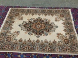 Large unmarked vintage wool rug with floral patterns - measures 132 x 98 inches