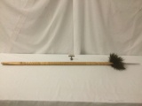 Long wooden Alaskan spear with peacock feathers, carved shaft and jagged bone tip