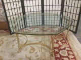 Modern hexagonal glass and gold finished metal base coffee table with hoofed legs