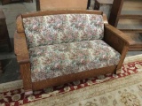 Antique turn of the century tiger oak hide-a-bed with floral upholstery