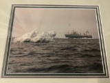 Framed photograph of ship at sea amongst icebergs, approx 20x18 inches.