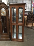 Modern curio cabinet with 3 glass shelves. Lighting tested and needs repair. Measures approx
