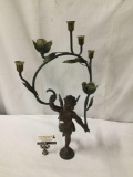 Metal Cupid candle holder.