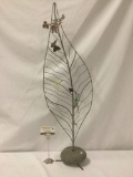 Large metal earring and jewelry standing holder w/ leaf design and dragon fly embellishments.