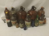 16 vintage jugs, bottles, and jars, approx. 24x17x16 inches.