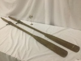 Pair of vintage wooden oars w/leather grips & metal mounts, approx. 72x6x3 inches.