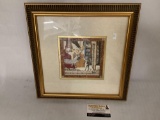 Framed cupid collage art, artist unknown, approx 14.5x14.5 inches.