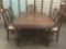 Vintage dark wood dining table, w/five floral upholstered vintage chairs, one of which has armrests.