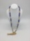 Northwest Coast style necklace with glass and bone beads and fossilized walrus bone fish pendant.