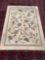Wool rug with floral pattern. Has some staining. Measures approx 134x92 inches. MB