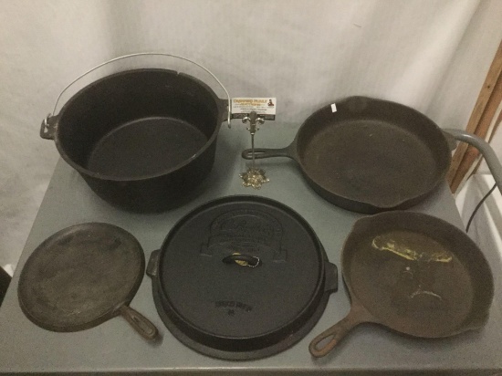 Three cast iron skillets and a Cabelas cast iron Dutch oven