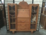 Vintage three drawer secretaries desk/curio cabinet, one cabinet door is locked shut w/dolls inside