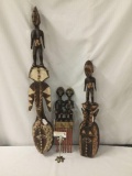 Three African hand carved wood wall hanging sculptures of men and women. Largest measures approx