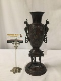 Metal vase/ urn with griffon and floral motif. Measures approx 13.5x6x6 inches. MB