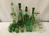 Collection of 28 pieces of green glass stemware. Largest decanter measures approx 15x4x4 inches. MB