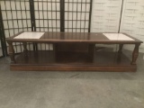 Wood coffee table w/two inlaid slabs of granite. Approx. 59x21x15 inches. JRL