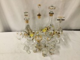 Collection of 20 pieces of clear and gold unmarked glass stemware. Largest decanter measures approx