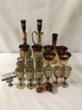 22 pieces of Amber and gold glass stemware. Largest decanter measures approx 15x5x5 inches. MB