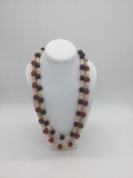 Pair of necklaces featuring many carved bone skull beads and red and blue Czech glass beads. The red