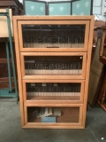 4 tier lawyer style cabinet with sliding glass fronts. Goes with Japanese books earlier in auction.