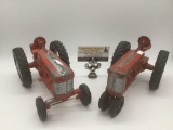 Pair of vintage red Hubley tractors, incl. one red Hubley tractor w/bucket seat & tow hitch, and one