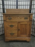 Late 1800s antique Eastlake style oak buffet table, w/casters and floral designs in drawers. Approx.