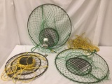 Three metal crab traps, two larger green traps and one smaller trap, the green traps are tied to