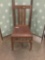 Vintage dining chair with leather seat.