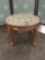 Vintage Paxton ottoman with woven floral pattern upholstery.