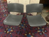 Pair of grey United Chair stacking metal/plastic chairs, approx 19x29x22