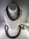 Pair of matching raspberry color glass beaded necklace, approx 34 inches round.