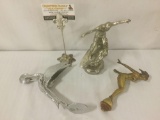 Vintage hood ornaments, one bronze and two metal ornaments, approx. 5x3x8.5 inches.