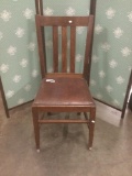 Vintage dining chair with leather seat.
