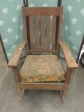 Vintage rocking chair with floral upholstery.