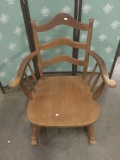 Vintage wide wooden rocking chair.