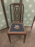 Vintage dining chair with woven seat cushion.