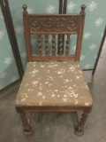 Vintage chair with spiral spindles and floral patterned upholstery.