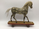 Antique/vintage toy horse attached to wheeled cart, shows wear see pics, approx. 11x3x11 inches.