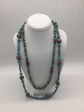 Jade necklace and blue glass necklace.