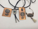 Two hammered copper necklaces, one bolo tie, and one wooden necklace.